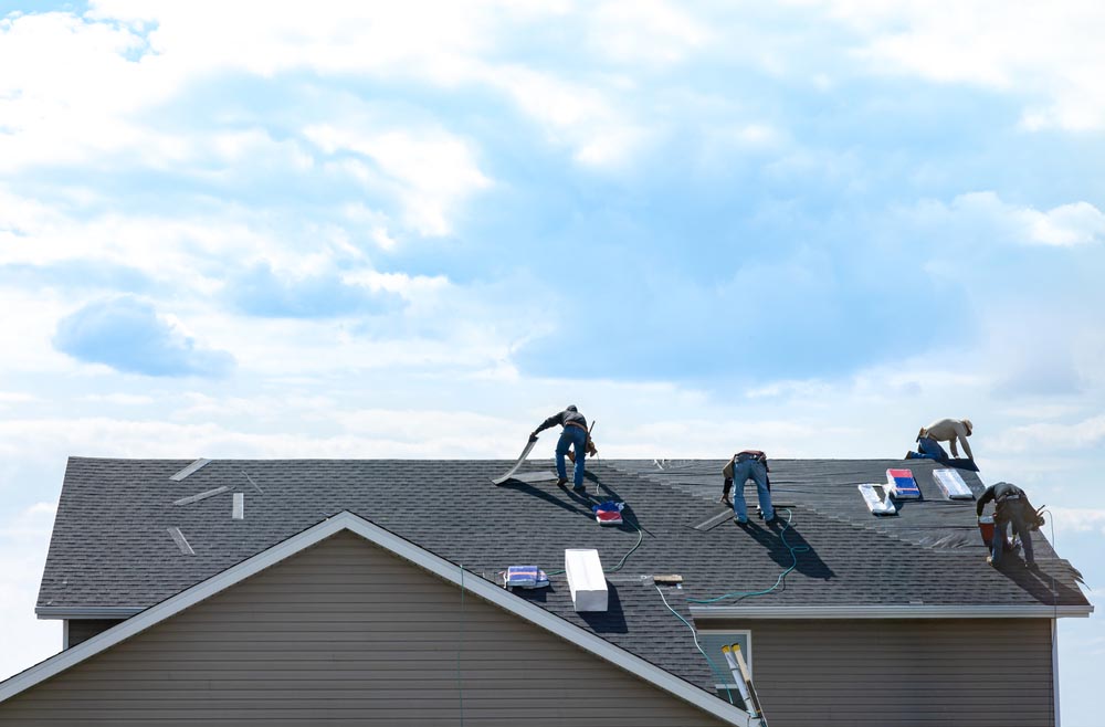 worker doing roof maintenance in Asheville, NC