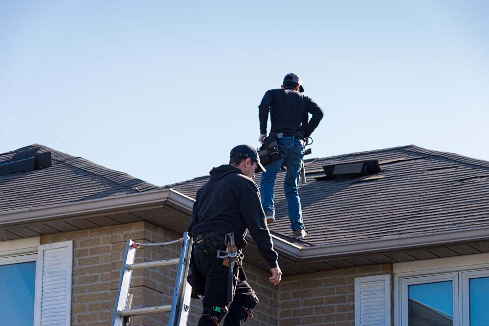 Contractor inspecting a roof