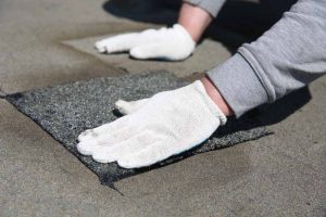 Secure Roofing technician working on spot repairs