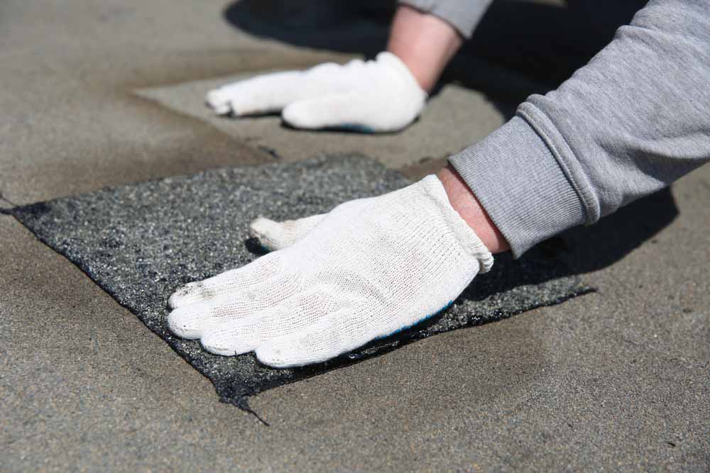 Secure Roofing technician working on spot repairs Secure Roofing technician working on spot repairs