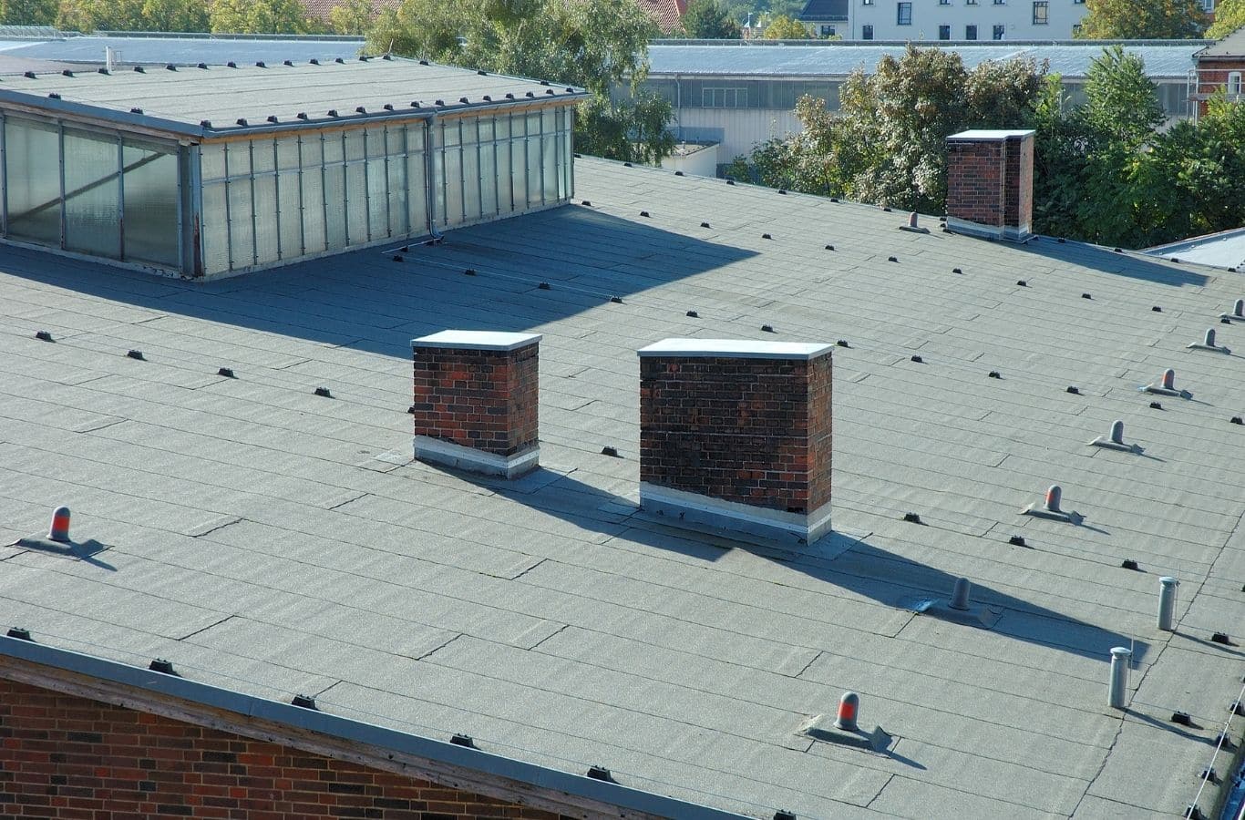 Secure Roofing technician performing commercial roofing in Hendersonville, NC using professional tools and safety-grade materials