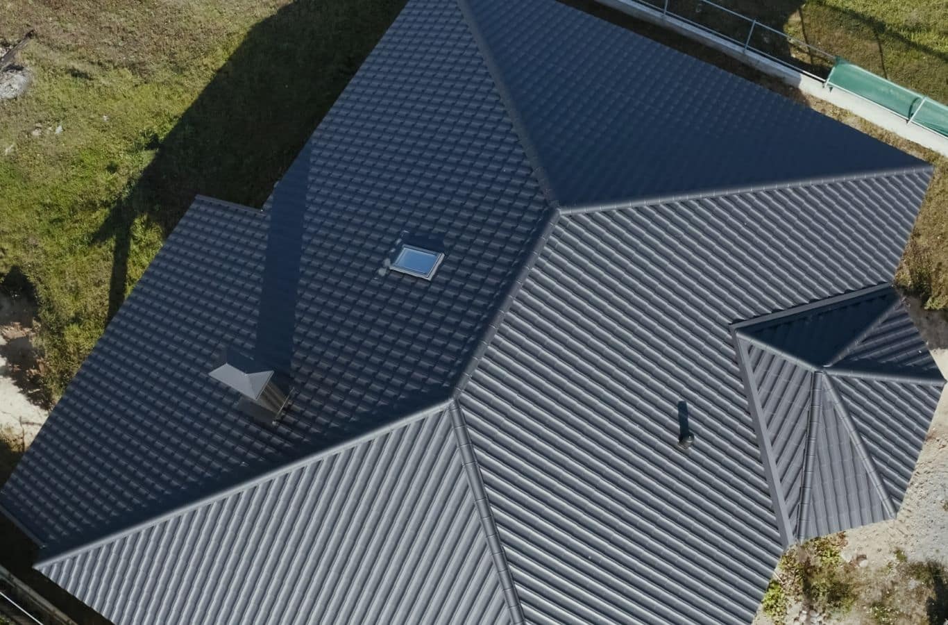 Secure Roofing technician installing metal roofing in Fletcher, NC using professional equipment for durable roofing performance.