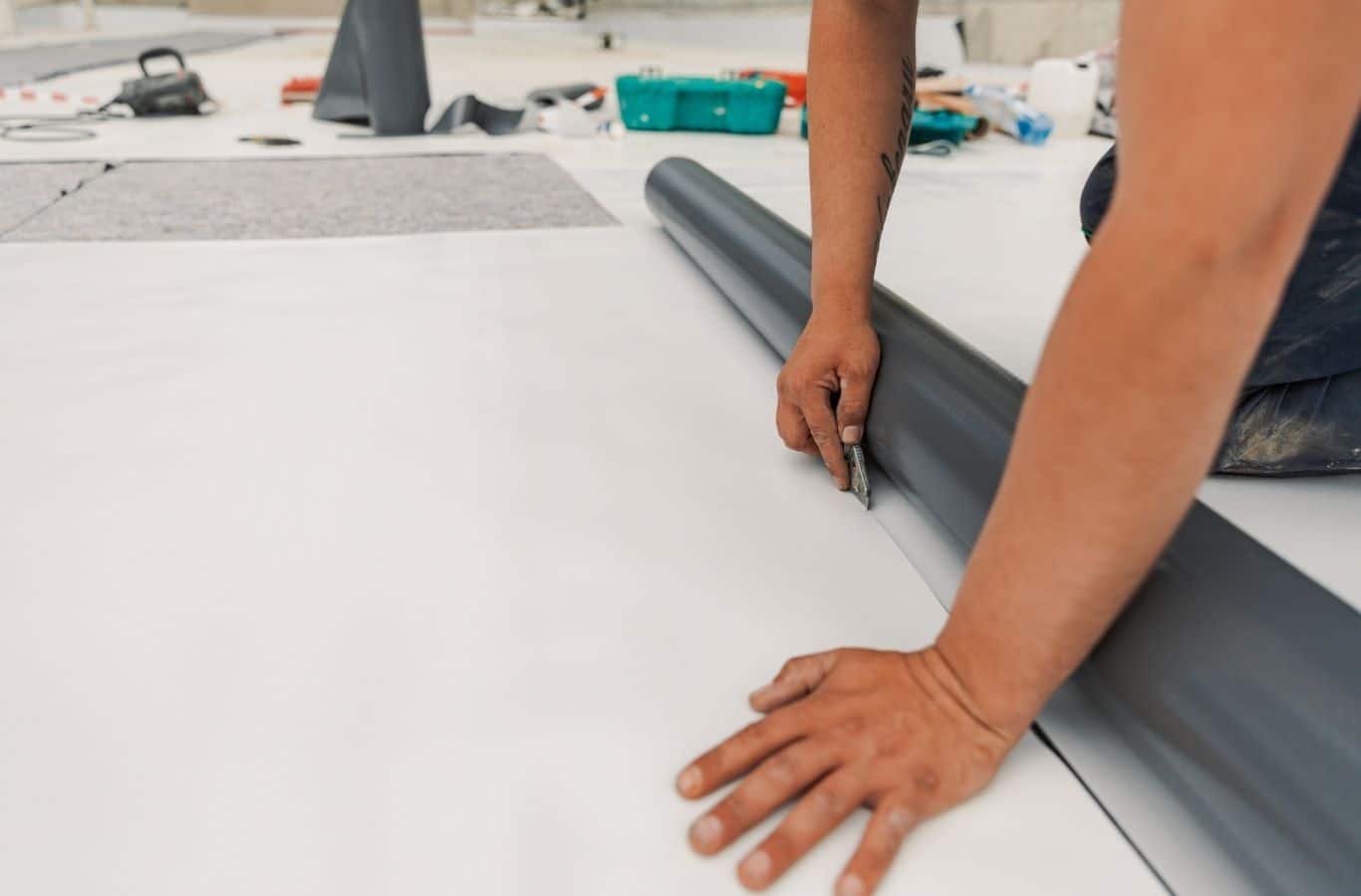Secure Roofing installer applying TPO roofing in Marshall, NC with specialized tools and precise membrane seams.